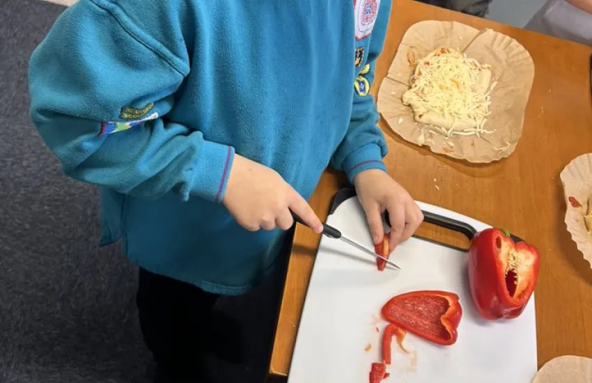 a beaver chopping red pepper