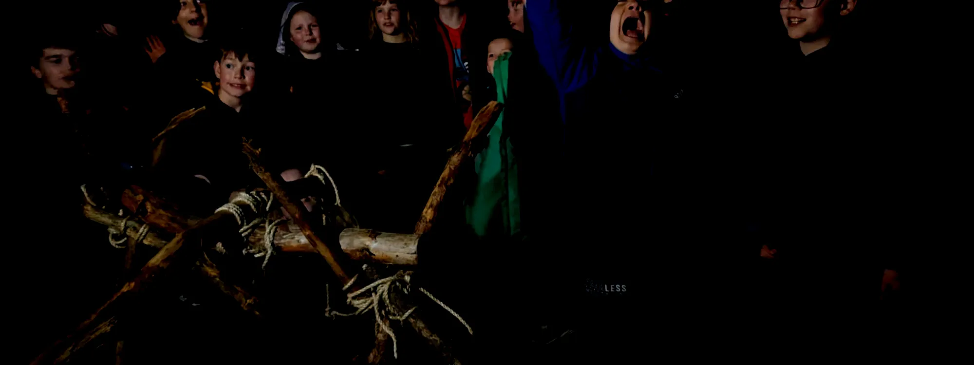 Scouts posing behind a bushcraft trebuchet