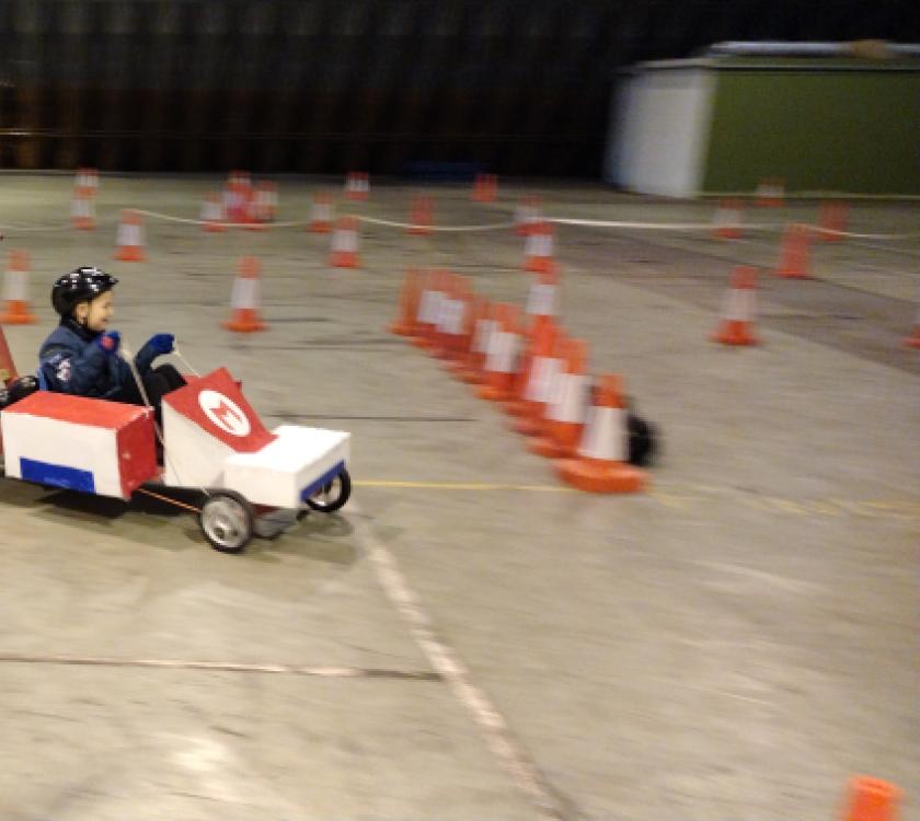 Scouts pushing a kart