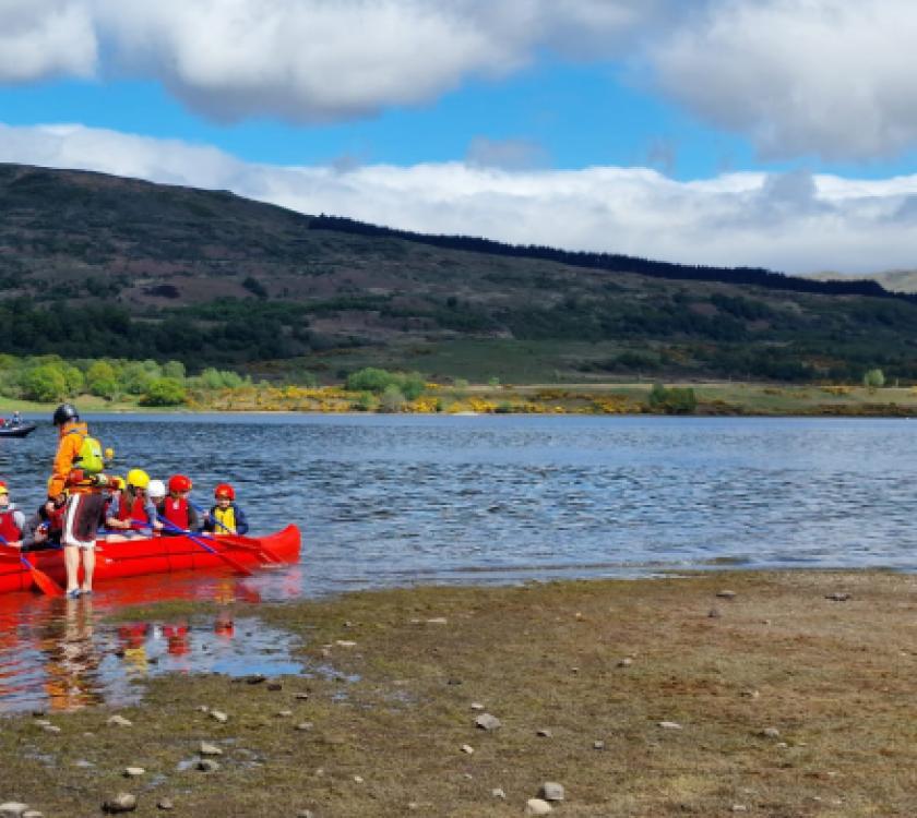 scouts in a canoe on a loch