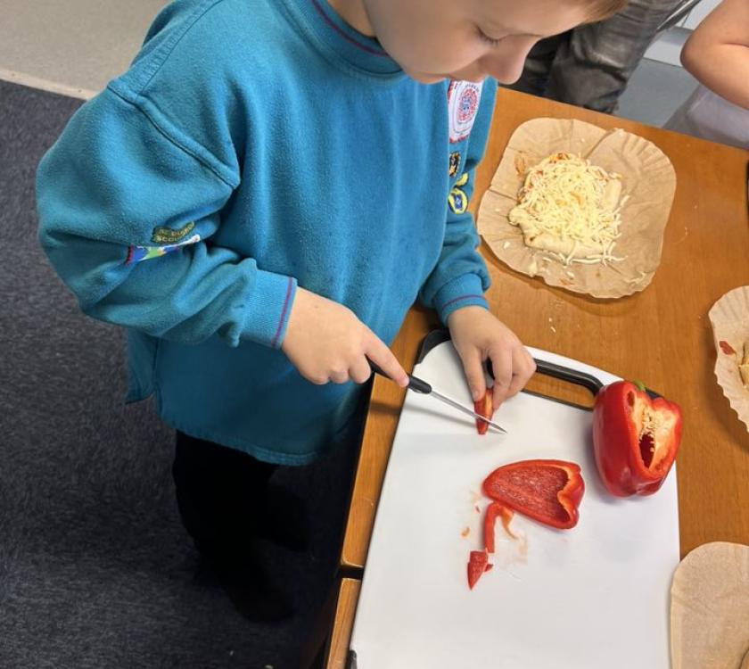 a beaver chopping red pepper