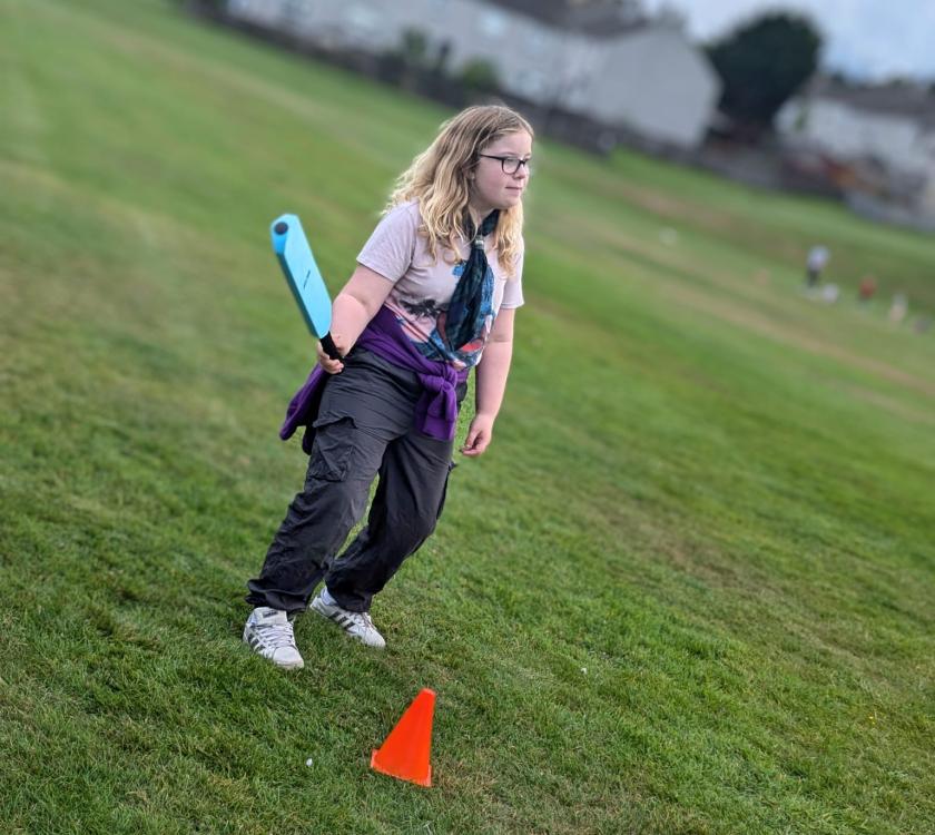 a scout getting ready to bat at rounders