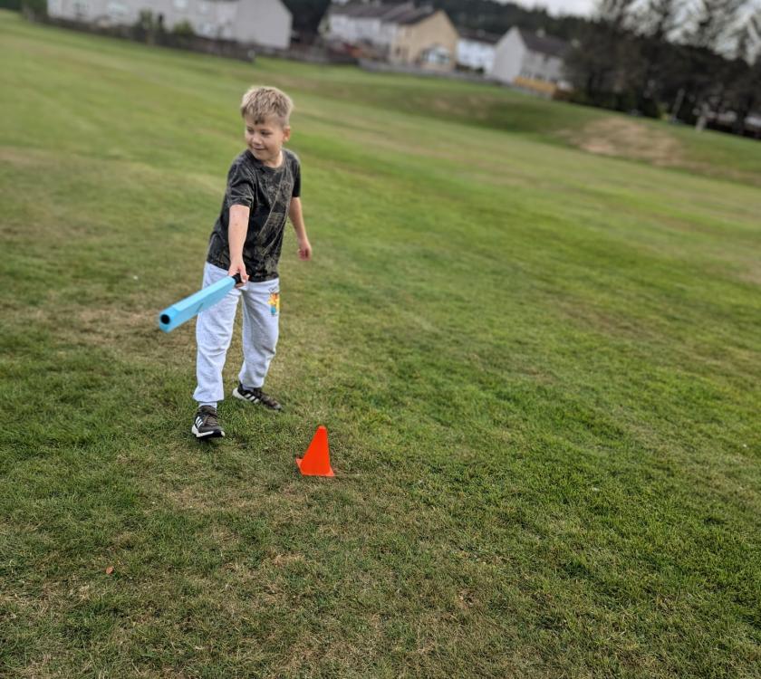 a male scout getting ready at rounders
