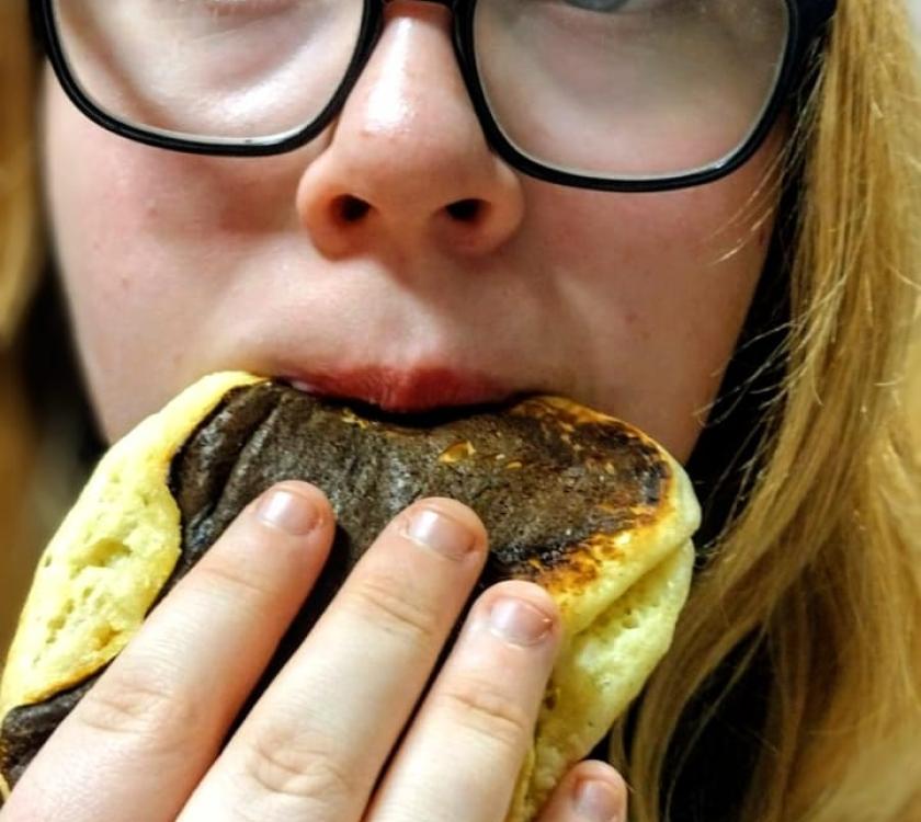 A scout eating a pancake 