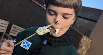 A cub eating toasted marshmallow